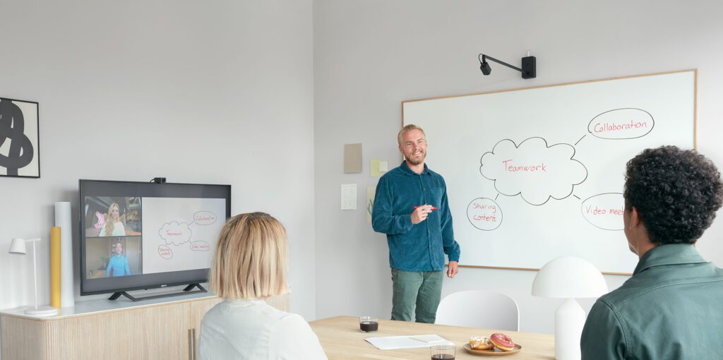 Photo of a meeting space showing the Huddly Canvas in action